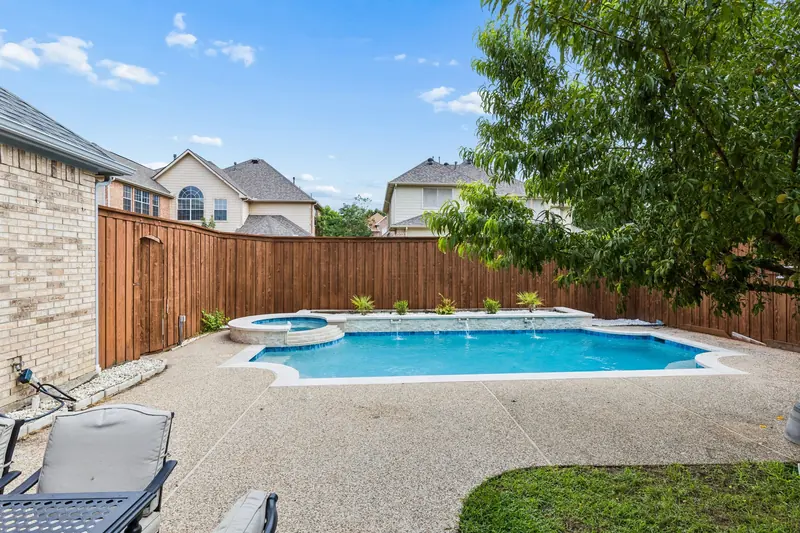 Backyard pool and spa with a patio